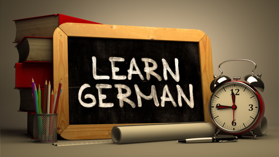 Learn German Concept Hand Drawn on Chalkboard.